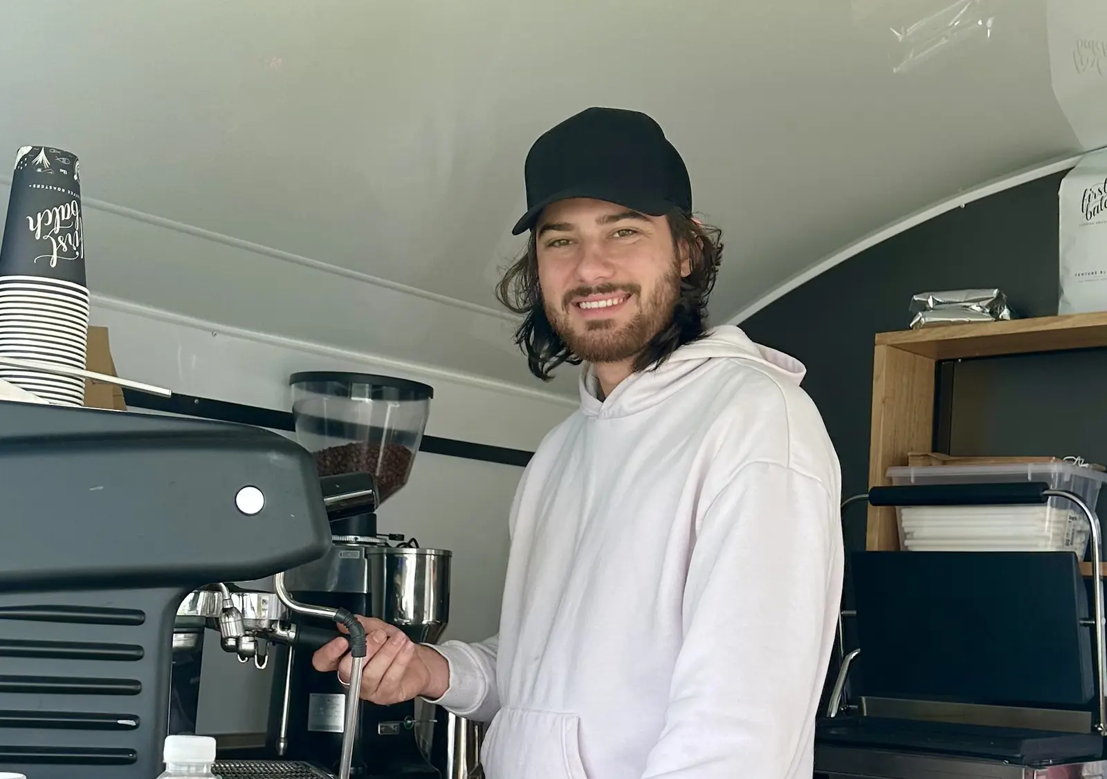 Braydon, Whiskey N Wine barista, at the espresso machine in the van